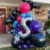 Halloween balloon installation with sparkly bats, silver stars, and black and bright colors by Just Peachy in Little Rock.