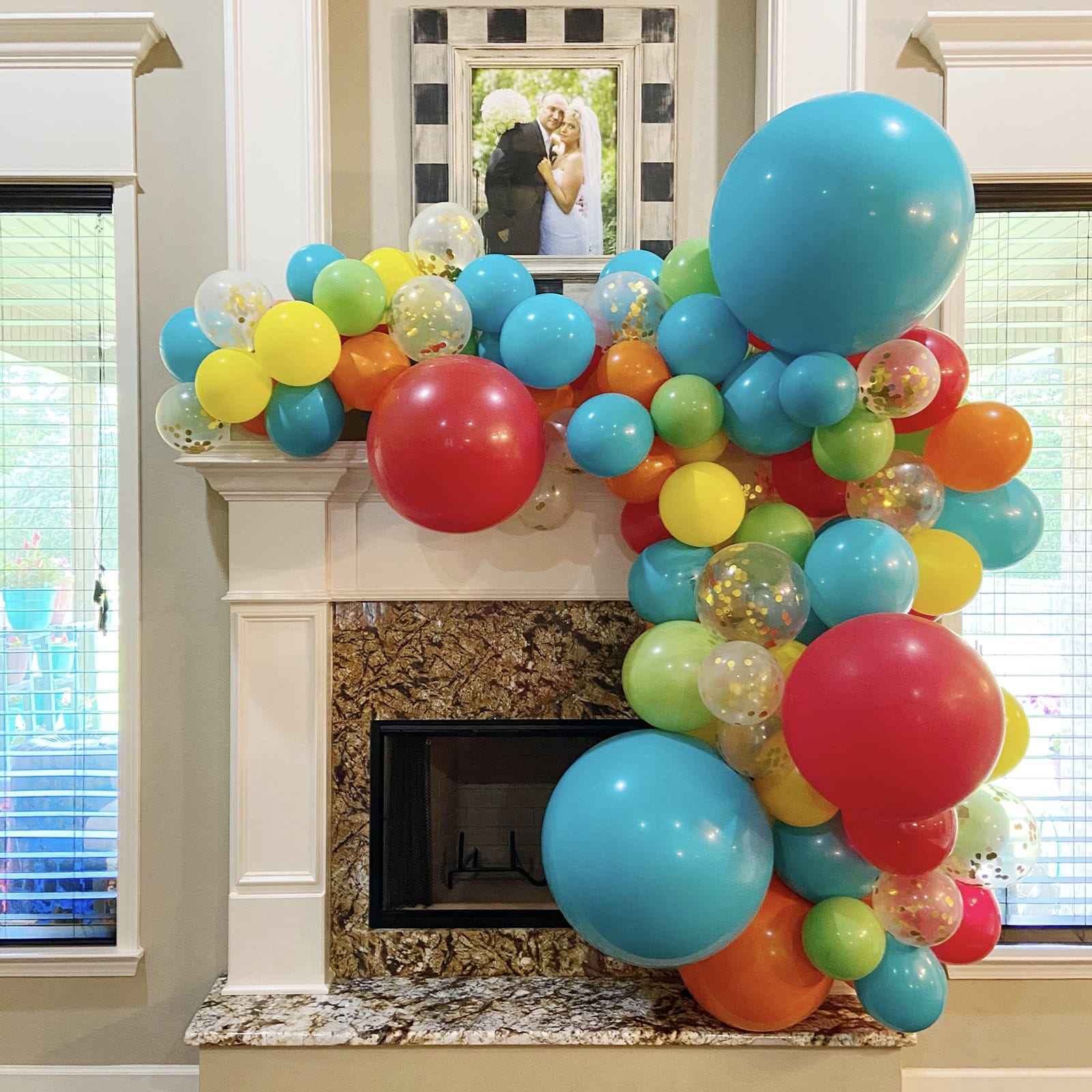 Make a mantle gorgeous with a balloon garland installation like this one for a Benton birthday with confetti balloons from Just Peachy.