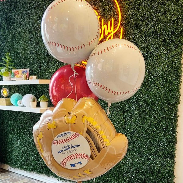 Helium bundles are available in a variety of themes, like baseball, with a giant glove, two baseball balloons, and a bright red orb.