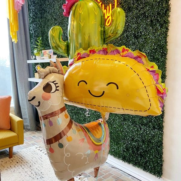 Make someone as happy as a llama with a helium bouquet like this one with giant taco, llama, and cactus balloons from Just Peachy.