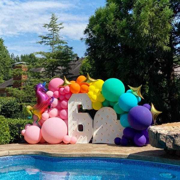 Events by the pool - we love to help with fun birthday party installs like this.