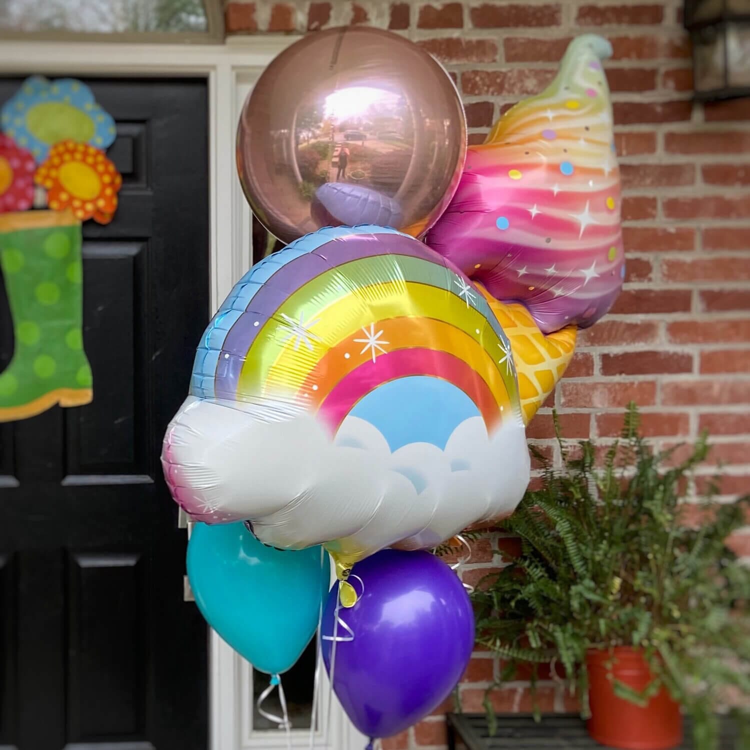 Oversized helium bouquet with ice cream cone, rainbow and shiny orb helium balloons from Just Peachy in Little Rock, Arkansas.