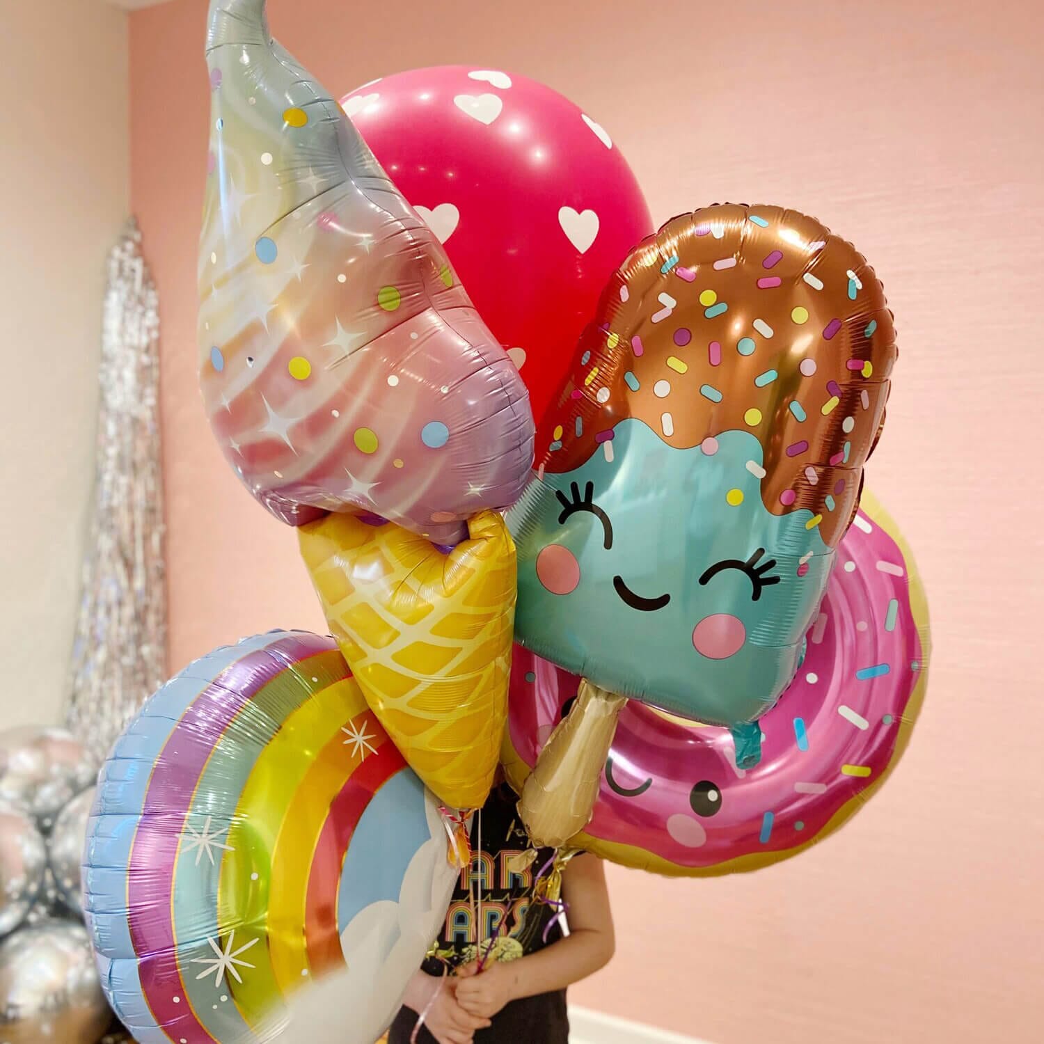 Just Peachy makes oversized helium bouquets like this one with ice cream, donut, rainbow, and popsicle balloons.
