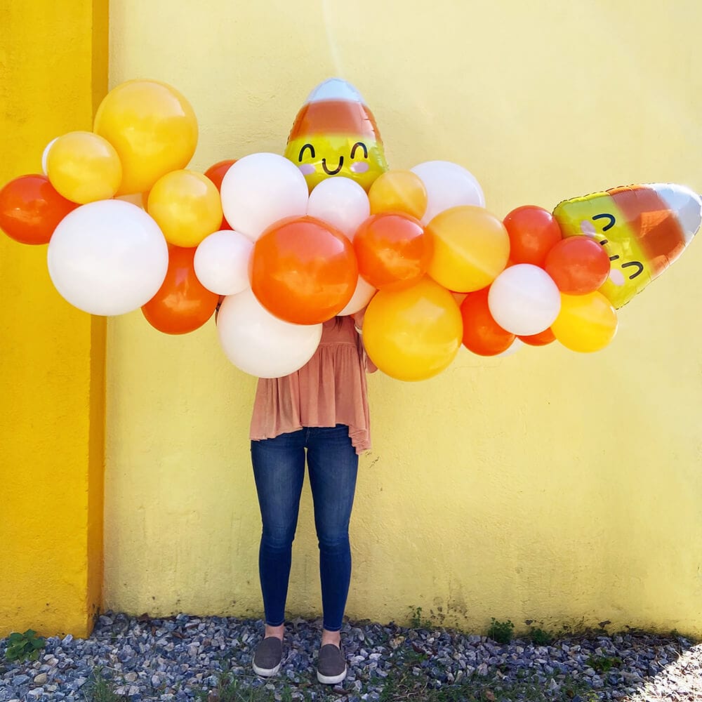 Candy corn foil balloons with orange, yellow, and white latex; Halloween garlands available from Just Peachy in Little Rock.
