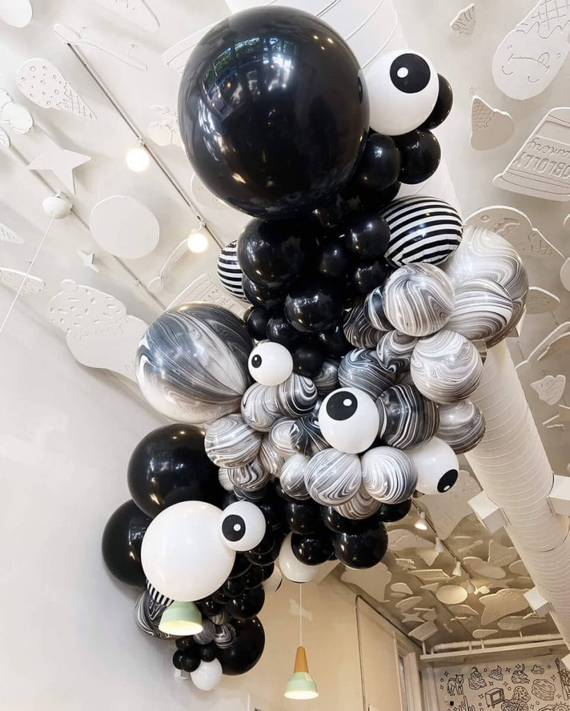 Black and white Halloween balloon ceiling arch by Just Peachy at Loblolly Creamery in Little Rock.