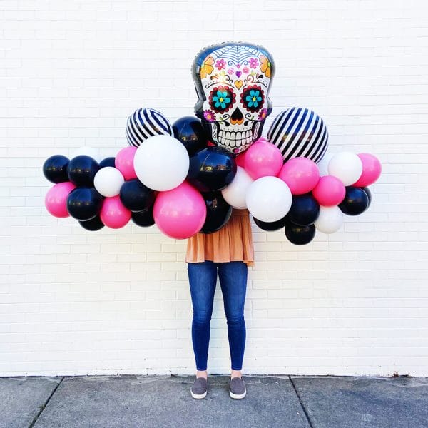 Pink, black, and striped balloons make up this Halloween Grab and Go Garland from Just Peachy in Little Rock.