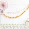 Pink, cream, gold, crepe paper banner from My Mind's Eye sold by Just Peachy in Little Rock, Arkansas.
