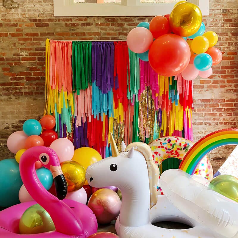 Just Peachy rents backdrops, like this multicolored streamer wall with balloons, for weddings, parties, showers, and events in central Arkansas.