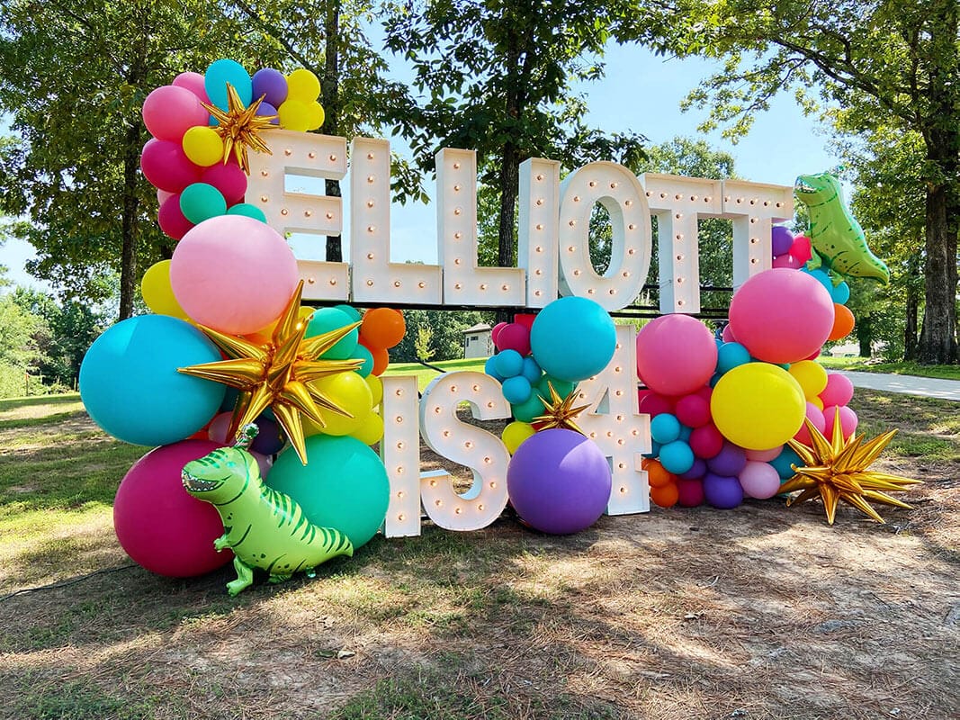 Just Peachy can create custom themed birthday balloon arch installations with Alpha-Lit marquee numbers like this 4 year old dinosaur party in Conway, Arkansas.