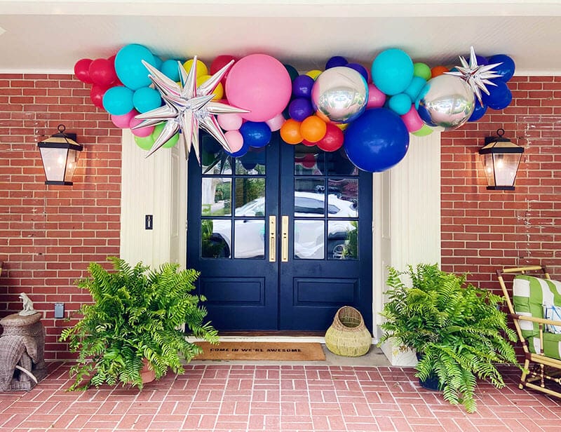Just Peachy's outdoor balloon garland arch install over front doors will get you ready for the party in central Arkansas.