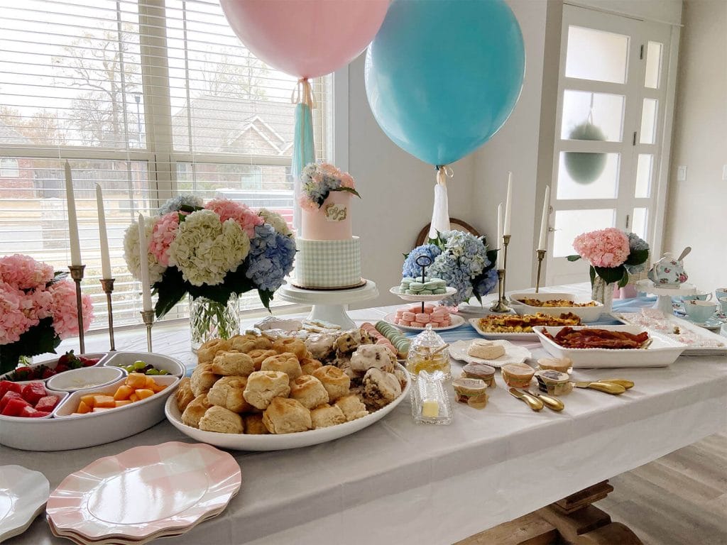 Breakfast table with pink and blue helium balloons and tassels by Just Peachy.