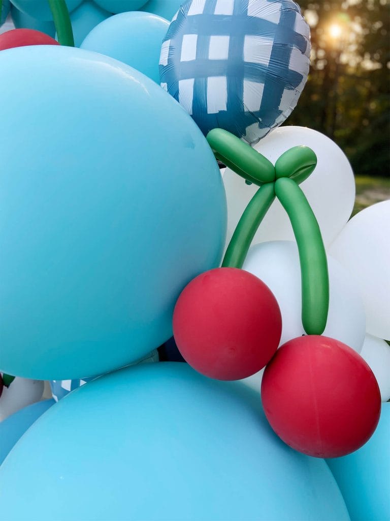 Jumbo blue latex balloons with hand shaped balloon cherries by Just Peachy.