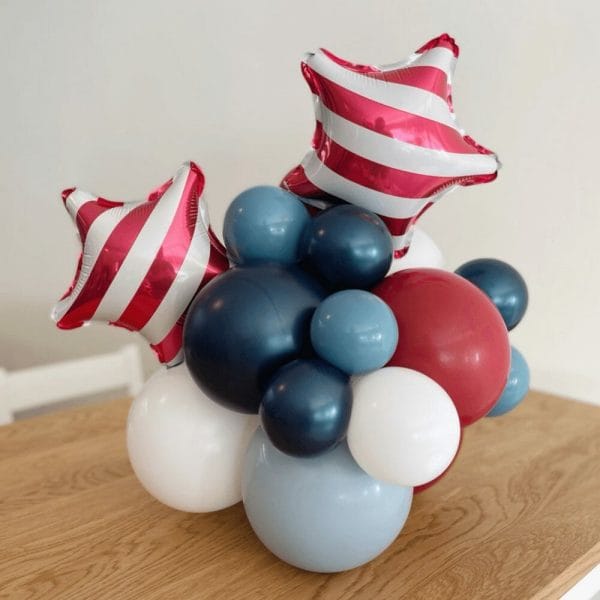 Red striped stars and patriotic balloons in a Tabletopper from Just Peachy for July 4th.