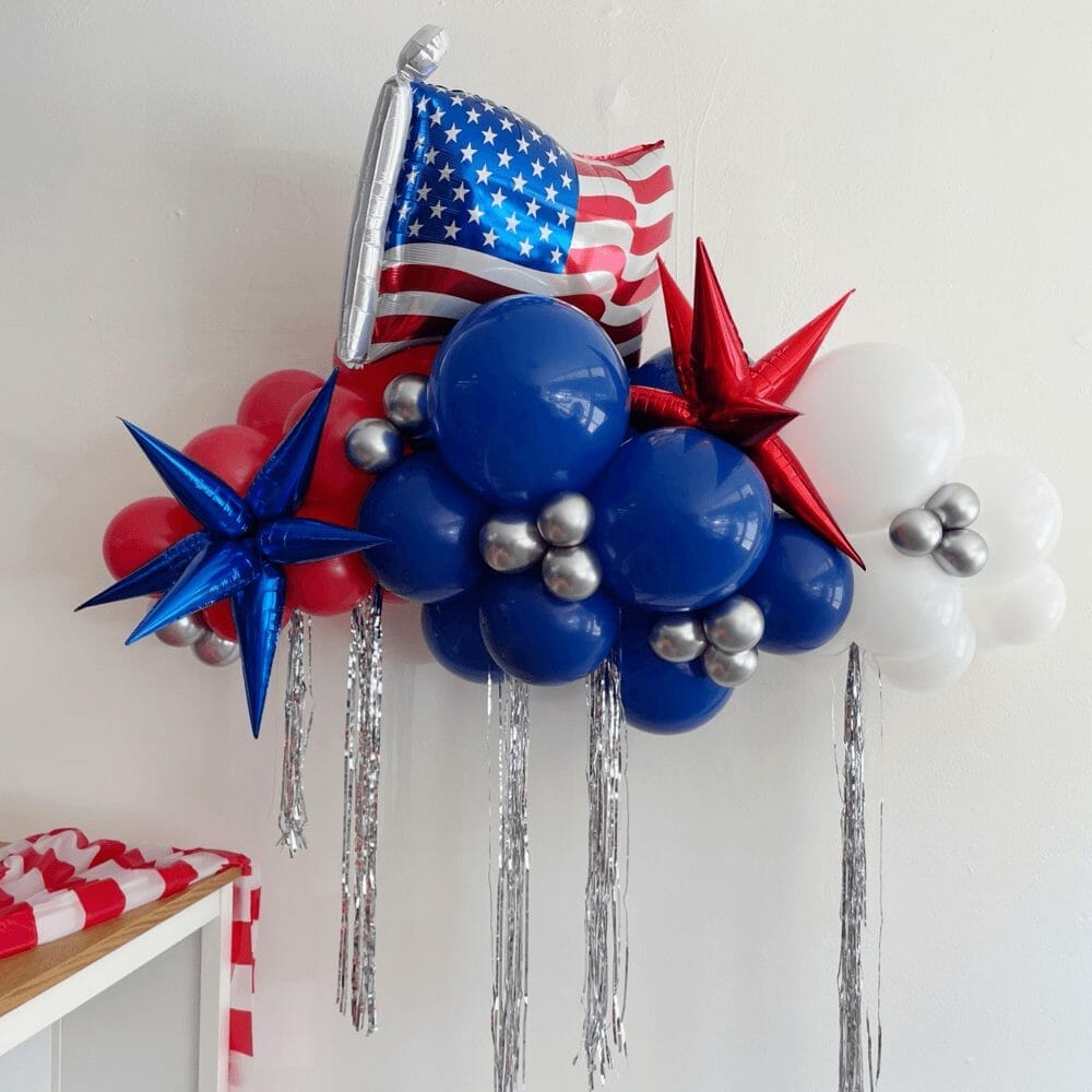 Red, white, blue and silver balloons and streamers make up a 4th of July garland from Just Peachy.