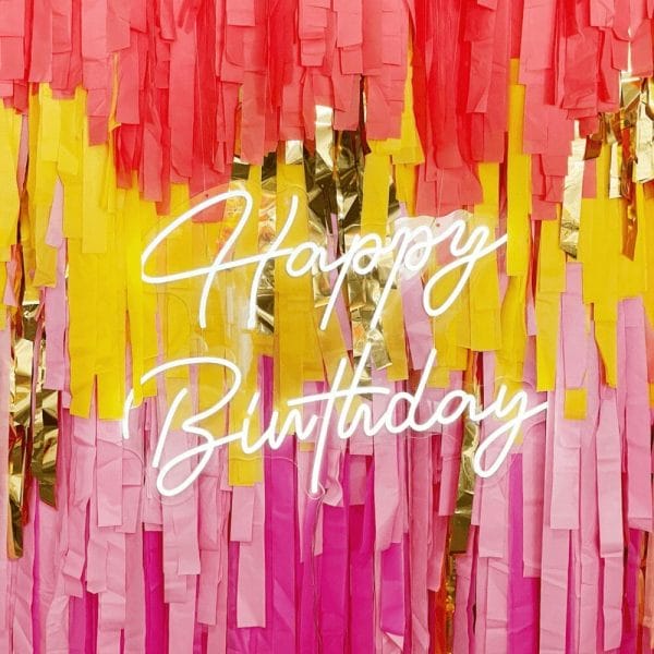 White script lettering spelling Happy Birthday hanging on a streamer backdrop; both available to rent from Just Peachy in Little Rock.